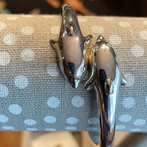 Silver hinged dolphin bracelet.